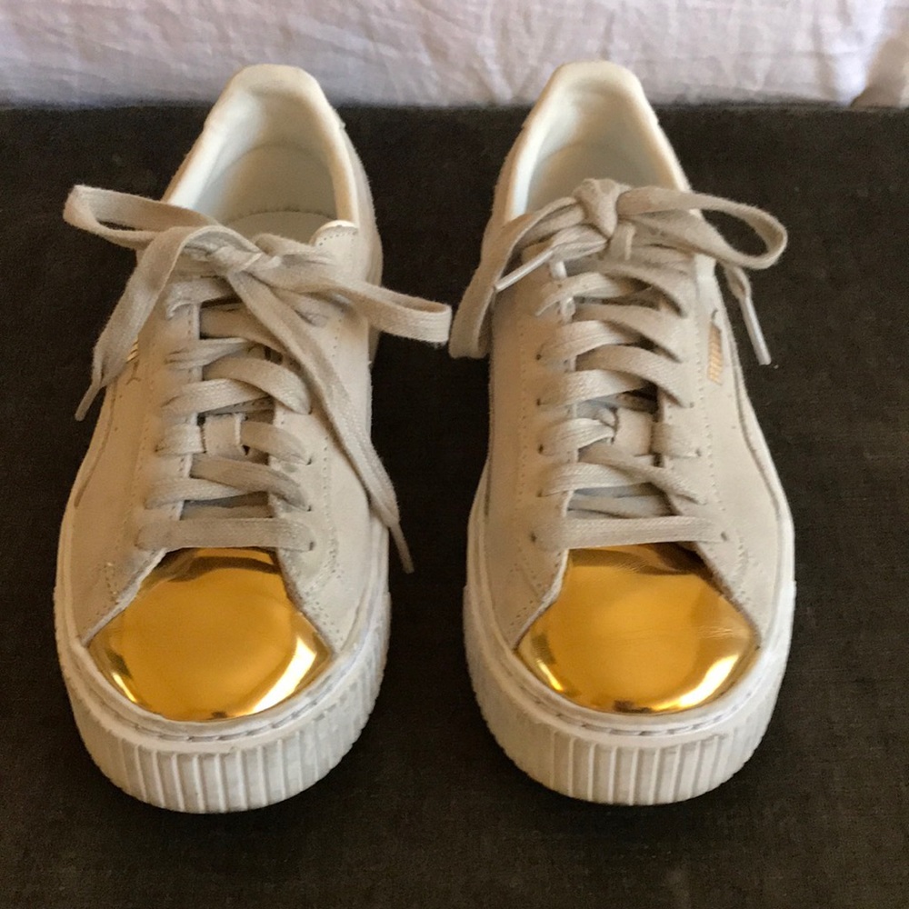 Puma platform basket sneakers in beige and gold.